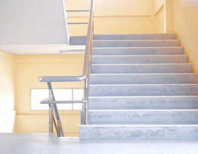 Escalera de concreto con direcciones y barandal de acero