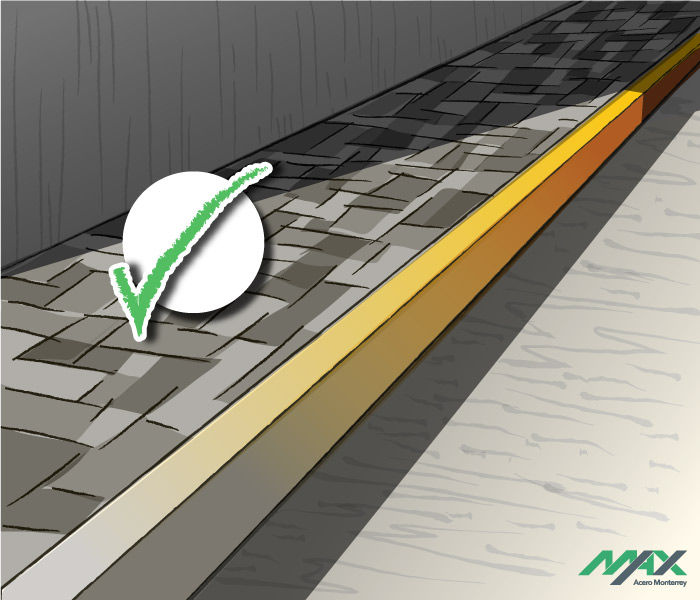 Guarnicion trapezoidal de concreto recién terminada pintada de amarillo