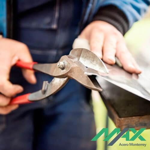 Trabajador realizando cortes con tijeras para lámina