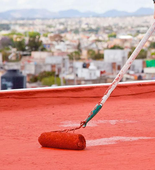 Trabajador aplicando impermeabilizante con un rodillo
